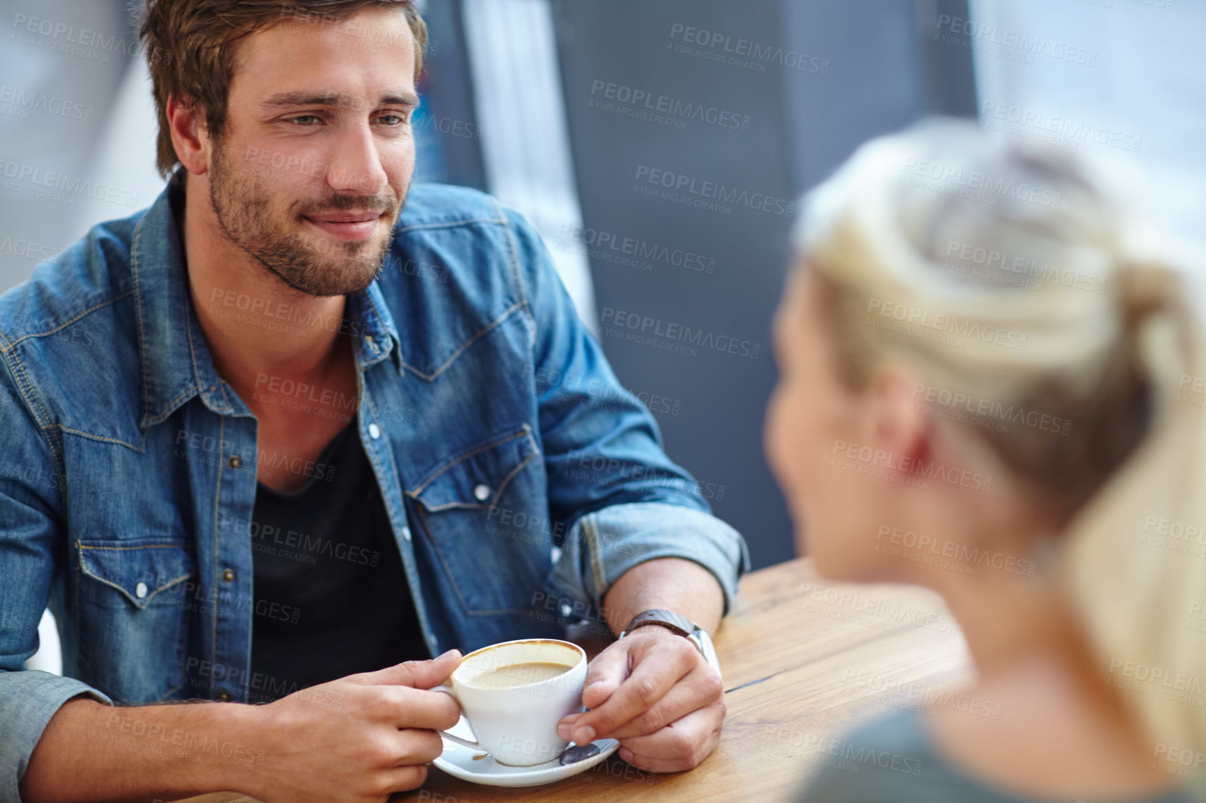 Buy stock photo Over the shoulder shot of a handsome young man on a coffee date with his girlfriend