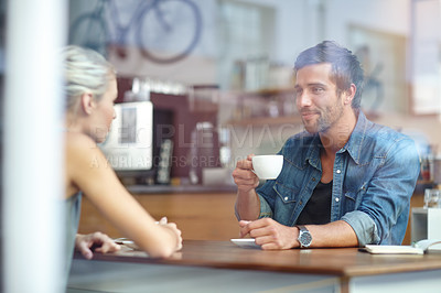 Buy stock photo Shot of a young couple enjoying a date at a coffee shop