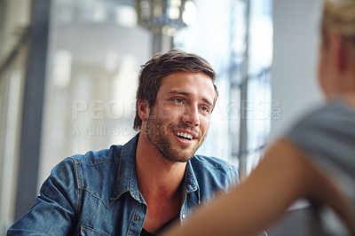 Buy stock photo Over the shoulder shot of a handsome young man on a coffee date with his girlfriend