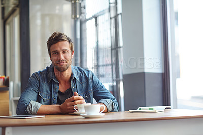 Buy stock photo Portrait of a handsome young man having coffee at a cafe