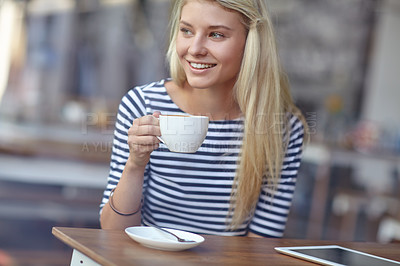 Buy stock photo Shot of a beautiful young woman drinking coffee at a cafe