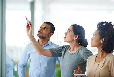 Buy stock photo Shot of a diverse group of coworkers brainstorming in the office