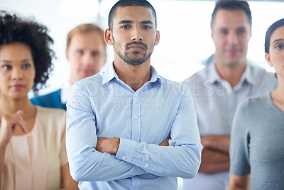 Buy stock photo Portrait of a handsome young business man with his colleagues in the background