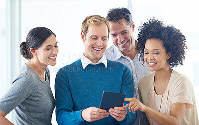 Buy stock photo Shot of a group of colleagues using a digital tablet together in an office
