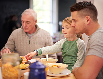 Buy stock photo Family, breakfast and kid eating food in home together for bonding with father in the morning. Cereal, parents and grandfather with child at table with pineapple, fruit and nutrition for healthy diet