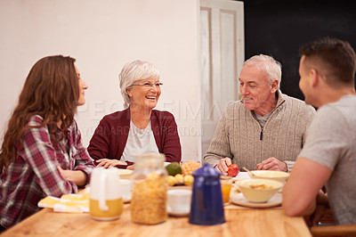 Buy stock photo Happy family, couple and senior parents at breakfast for talking, bonding and laugh together in the morning. Food, elderly mother and father with adults eating fruit, cereal and conversation in home