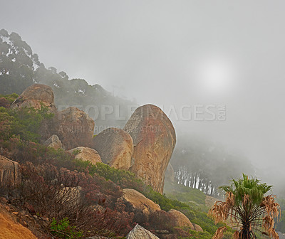 Buy stock photo A misty morning on peaceful mountain peak, quiet zen nature with scenic views. Smog covered rocky landscape of Lions Head mountain. The aftermath of a devastating wildfire on a mountain.