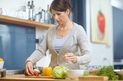 Buy stock photo Shot of an attractive woman preparing food in the kitchen