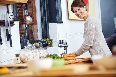 Buy stock photo Shot of an attractive woman washing her hands at the kitchen sink