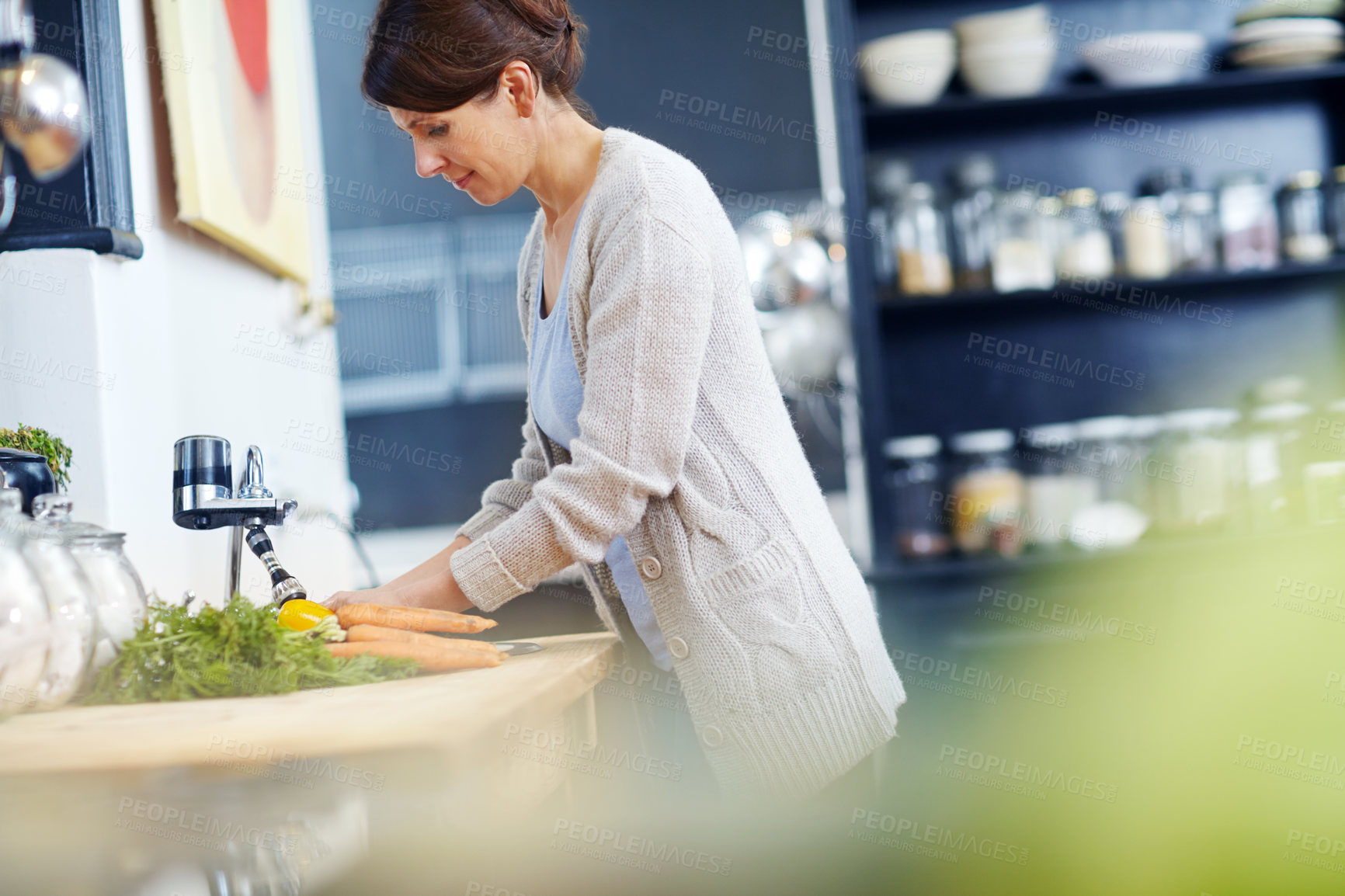 Buy stock photo Shot of an attractive woman washing her hands at the kitchen sink