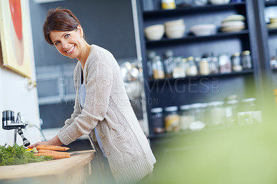 Buy stock photo Shot of an attractive woman washing her hands at the kitchen sink