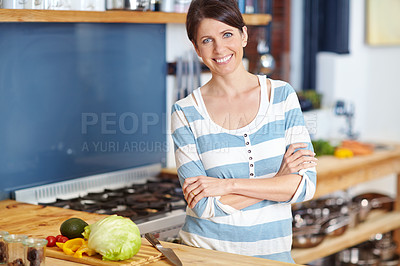 Buy stock photo Portrait of an attractive woman standing behind a kitchen counter filled with vegetables