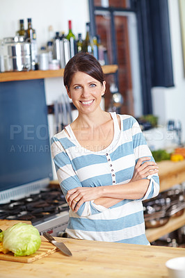 Buy stock photo Portrait of an attractive woman standing behind a kitchen counter filled with vegetables