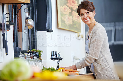 Buy stock photo Portrait of a beautiful woman preparing a meal in the kitchen