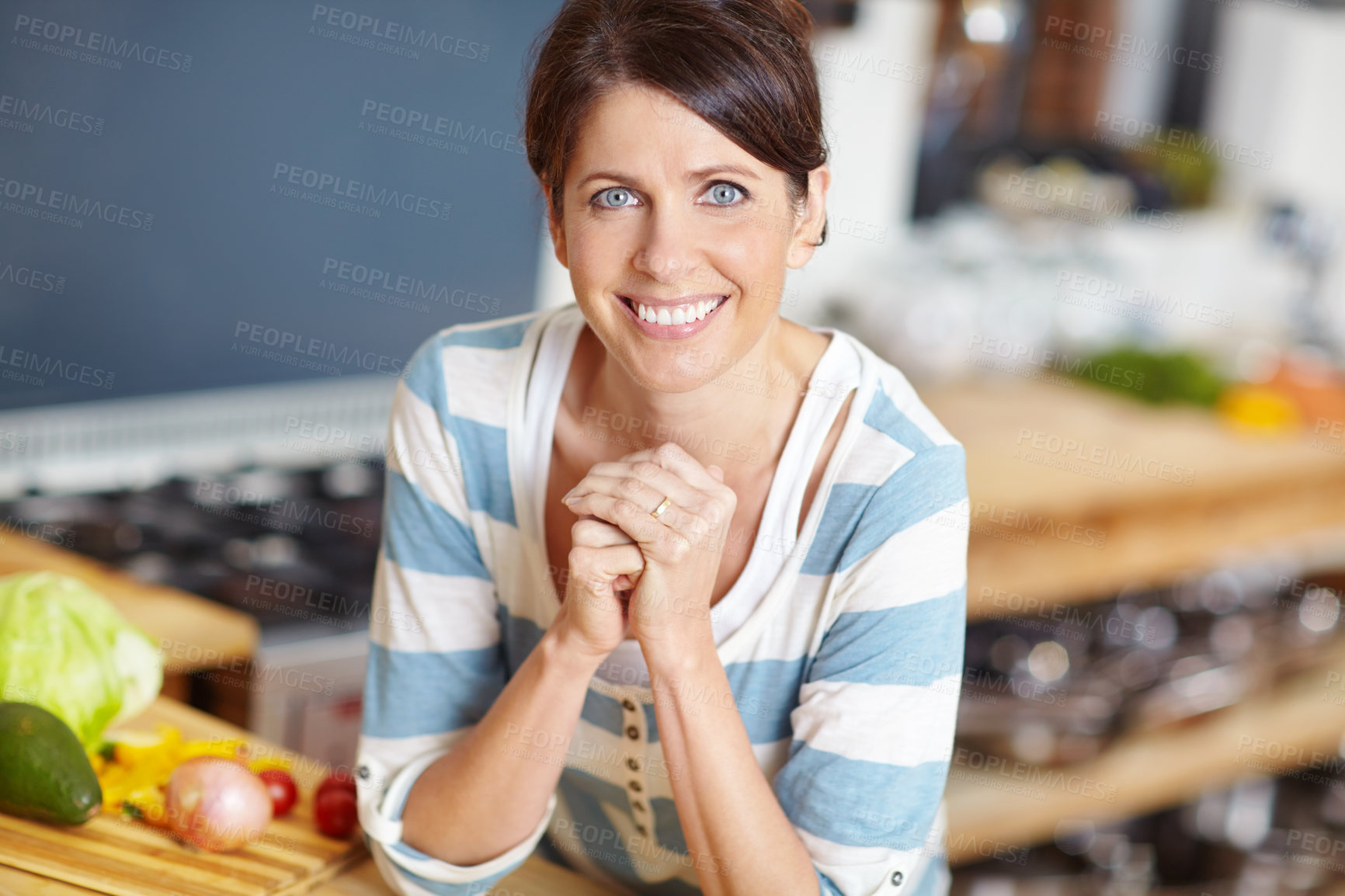 Buy stock photo Portrait of a beautiful woman leaning against the countertop in her kitchen