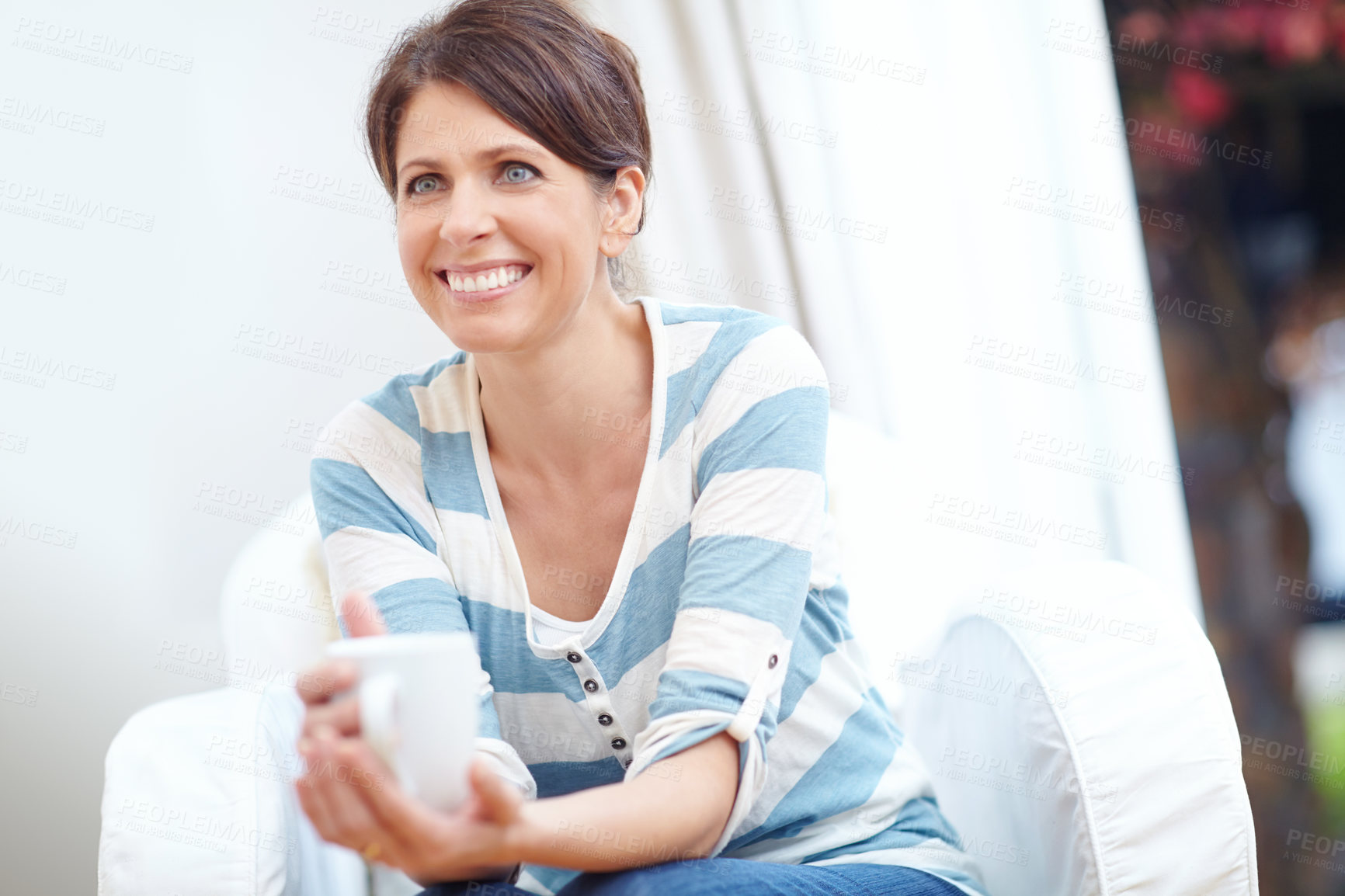 Buy stock photo Shot of a beautiful woman enjoying a cup of coffee at home