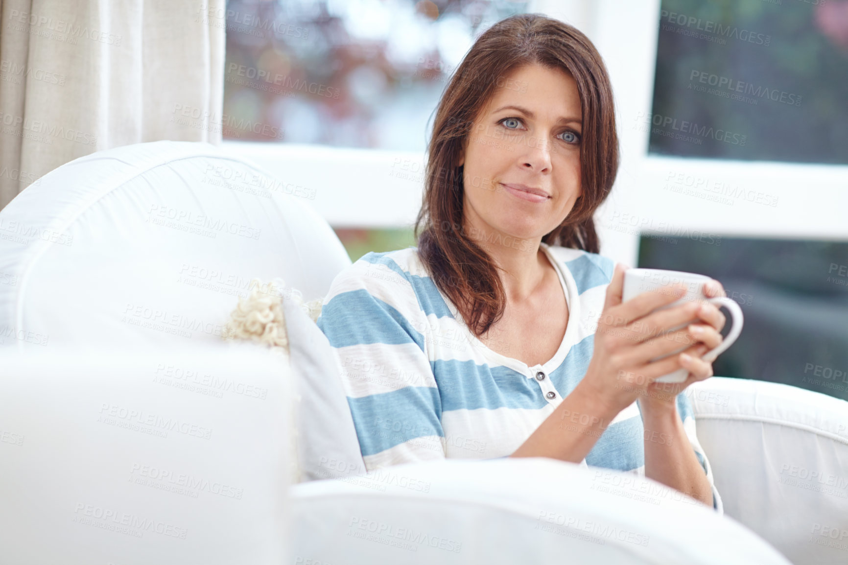 Buy stock photo Portrait of a beautiful woman enjoying a cup of coffee at home