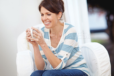 Buy stock photo Shot of a beautiful woman enjoying a cup of coffee at home