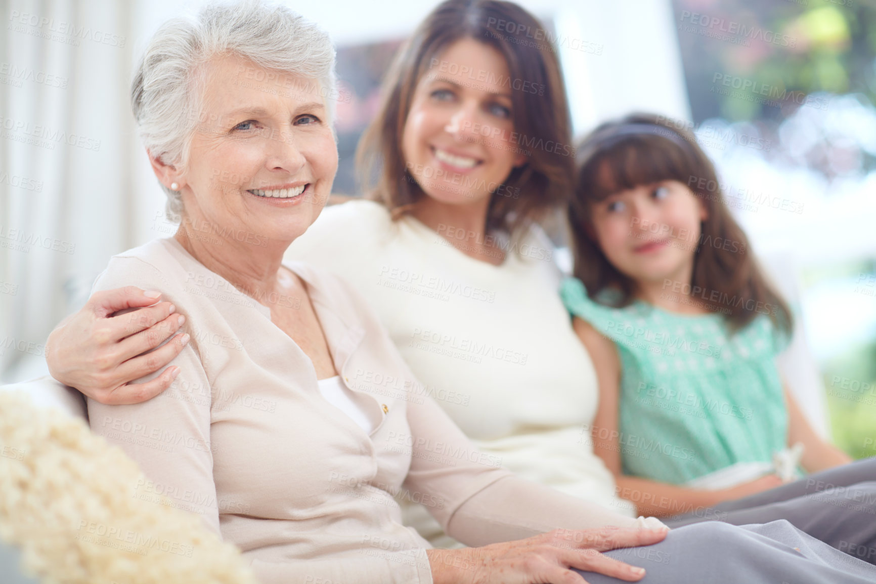 Buy stock photo Smile, portrait and senior woman with family on sofa in living room for bonding together at home. Happy, rest and elderly person with daughter and grandchild for generations connection at house.