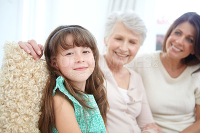Buy stock photo Portrait of a cute little girl spending time with her mother and grandmother at home