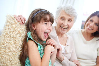 Buy stock photo Shot of a cute little girl spending time with her mother and grandmother at home