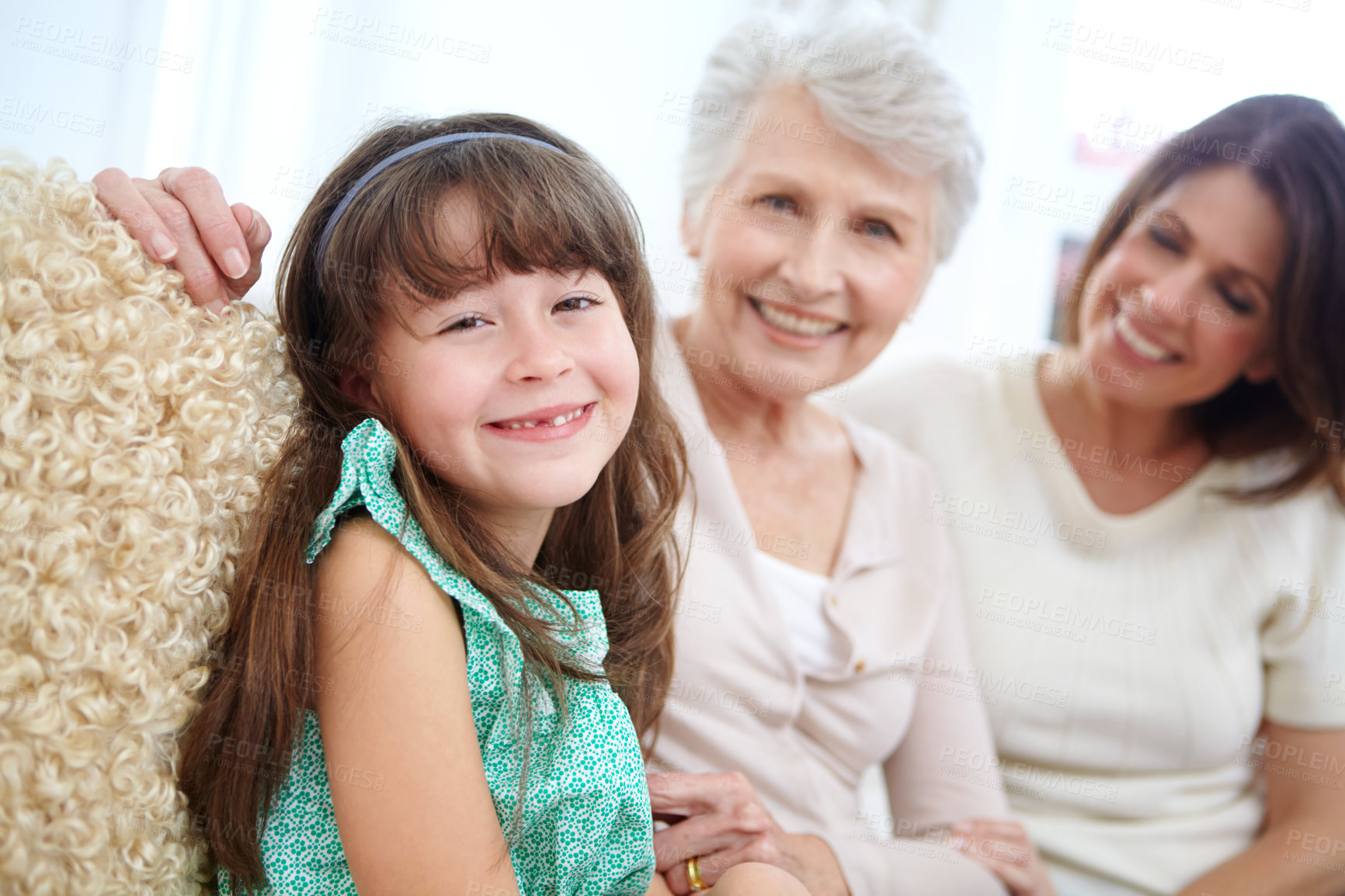 Buy stock photo Portrait of a cute little girl spending time with her mother and grandmother at home