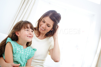 Buy stock photo Shot of a cute little girl spending time with her mother at home