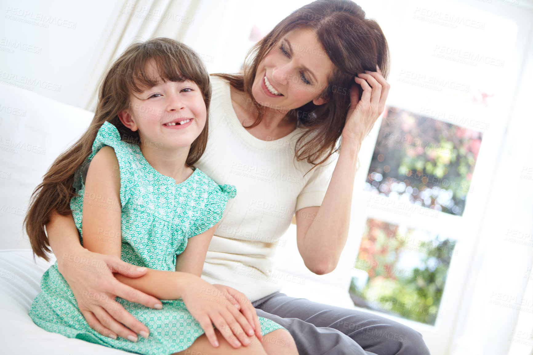 Buy stock photo Hug, mom and child in house on sofa, motherhood and bonding together in home. Mothers Day, portrait and happy family in bedroom with daughter, embrace and connection for childhood development.