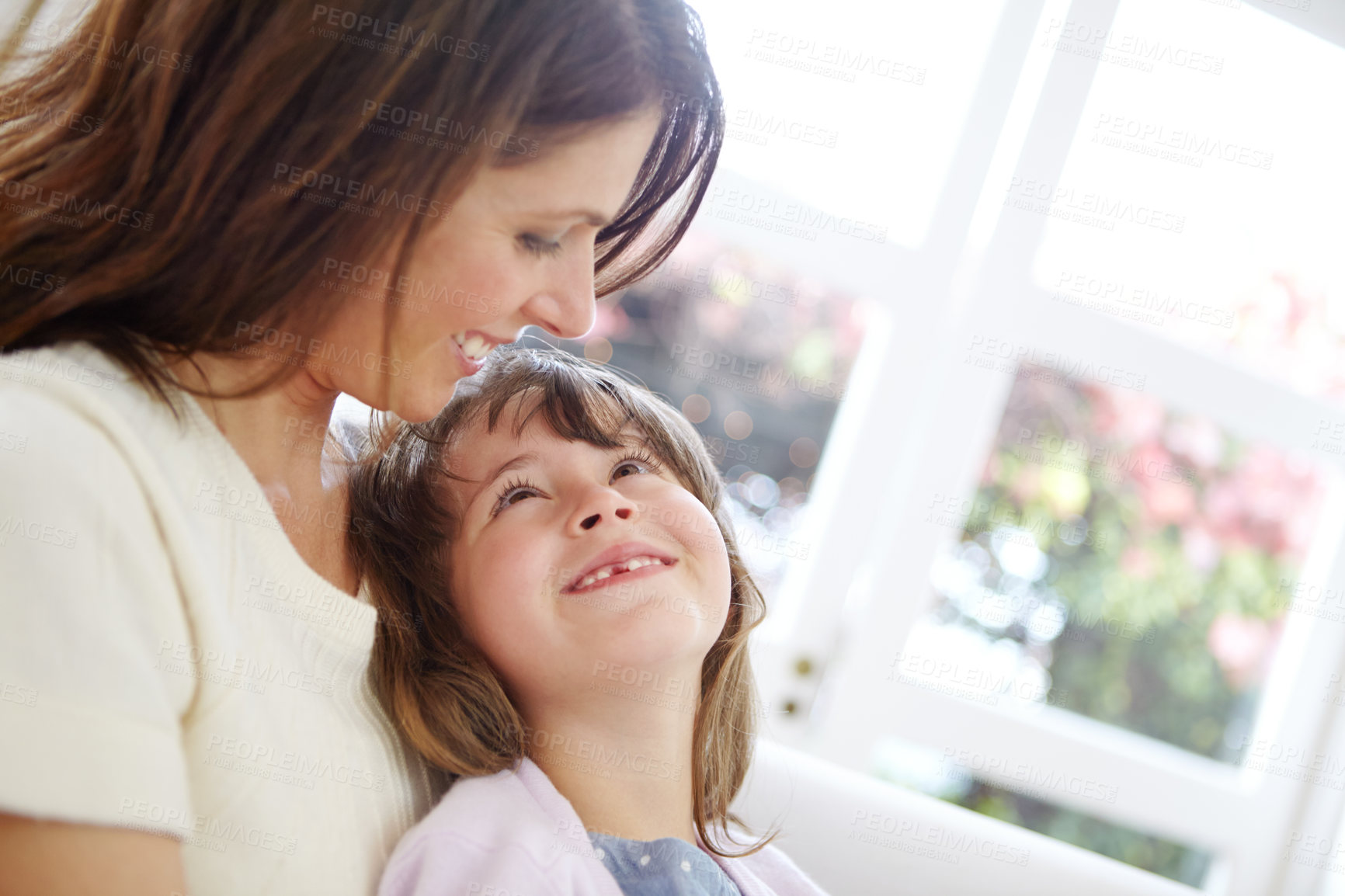 Buy stock photo Shot of a loving mother and daughter spending time together at home