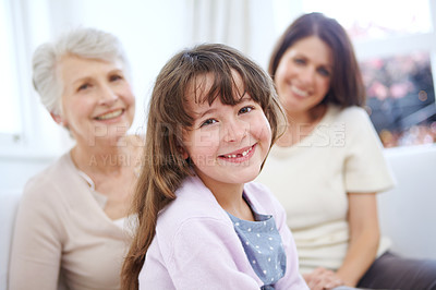 Buy stock photo Portrait of an adorable little girl with her mother and grandmother in the background