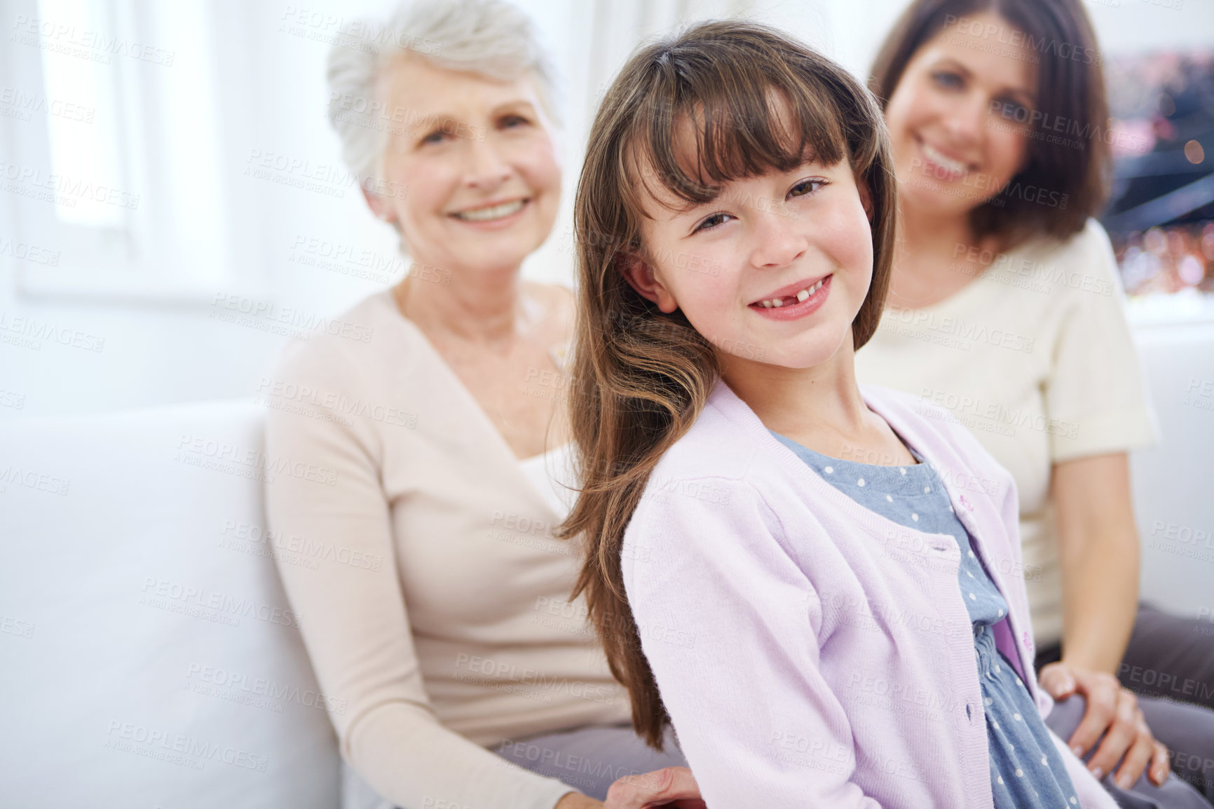 Buy stock photo Portrait of an adorable little girl with her mother and grandmother in the background