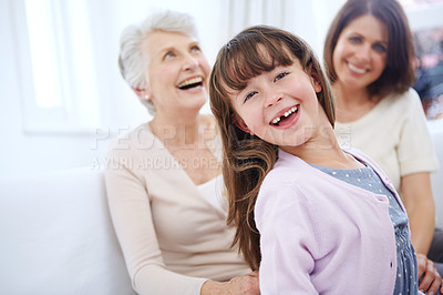 Buy stock photo Portrait of an adorable little girl with her mother and grandmother in the background