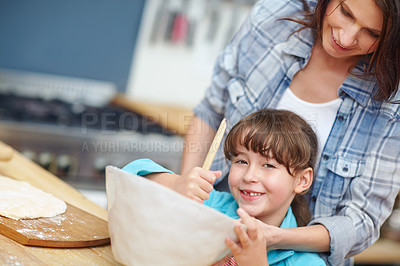 Buy stock photo Shot of a mother and daughter baking together