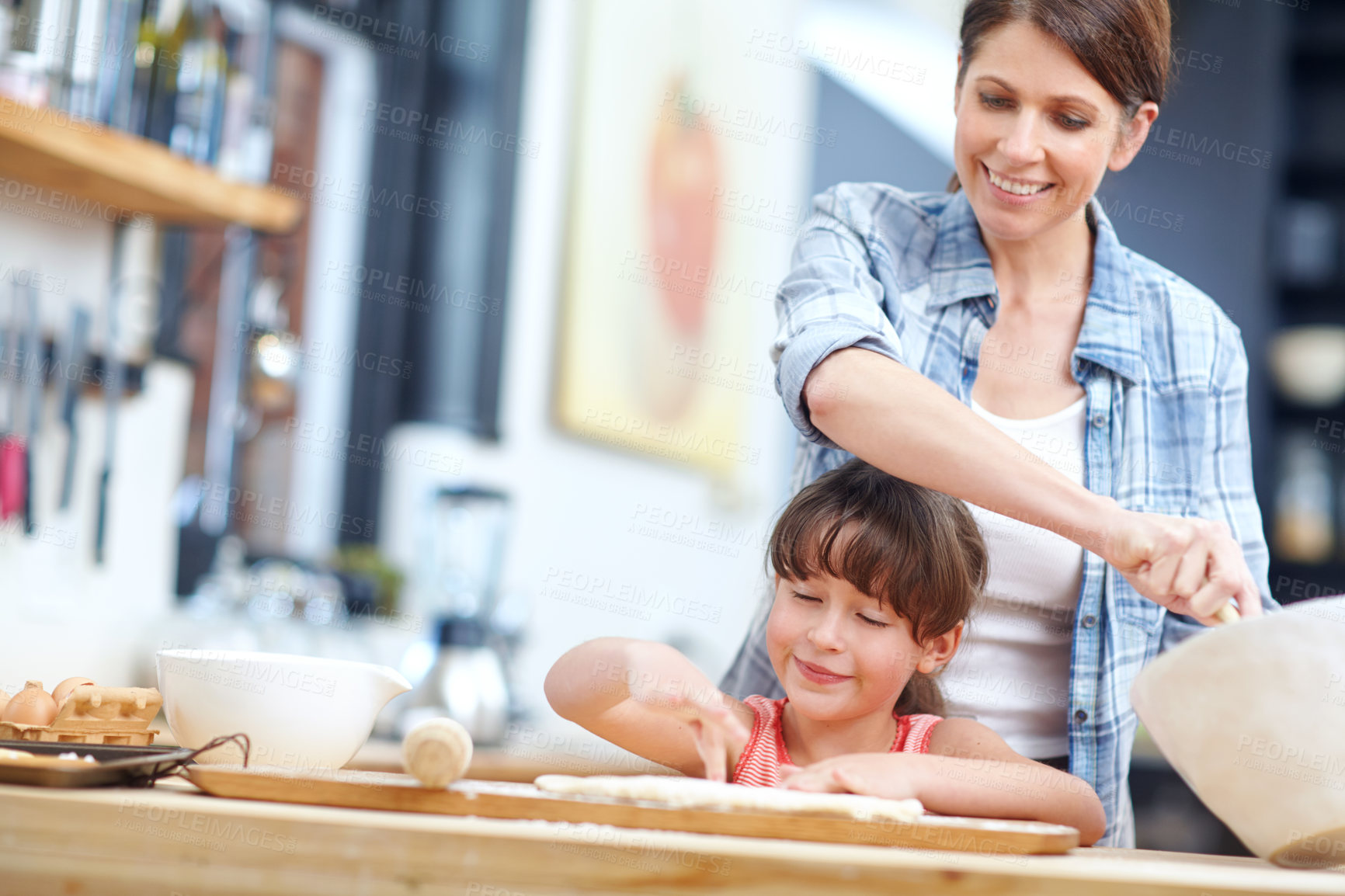 Buy stock photo Shot of a mother and daughter baking together