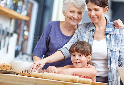 Buy stock photo Shot of a three generational family baking together