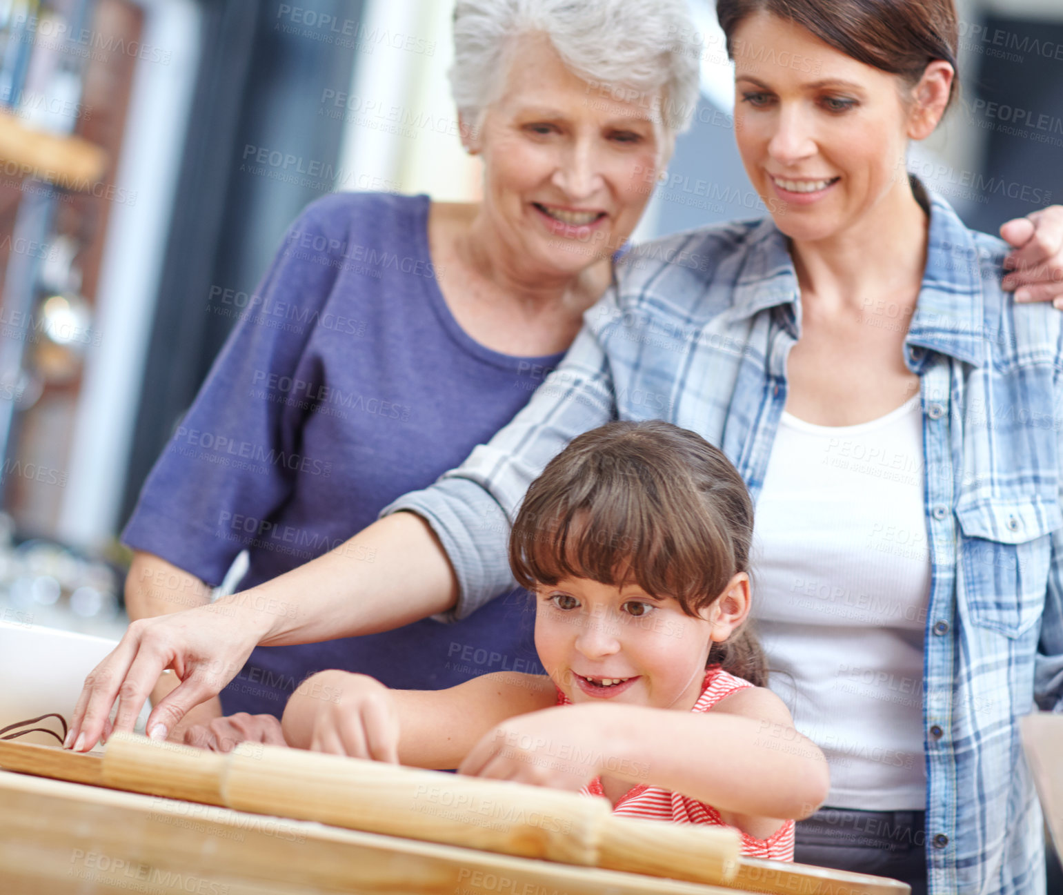 Buy stock photo Shot of a three generational family baking together