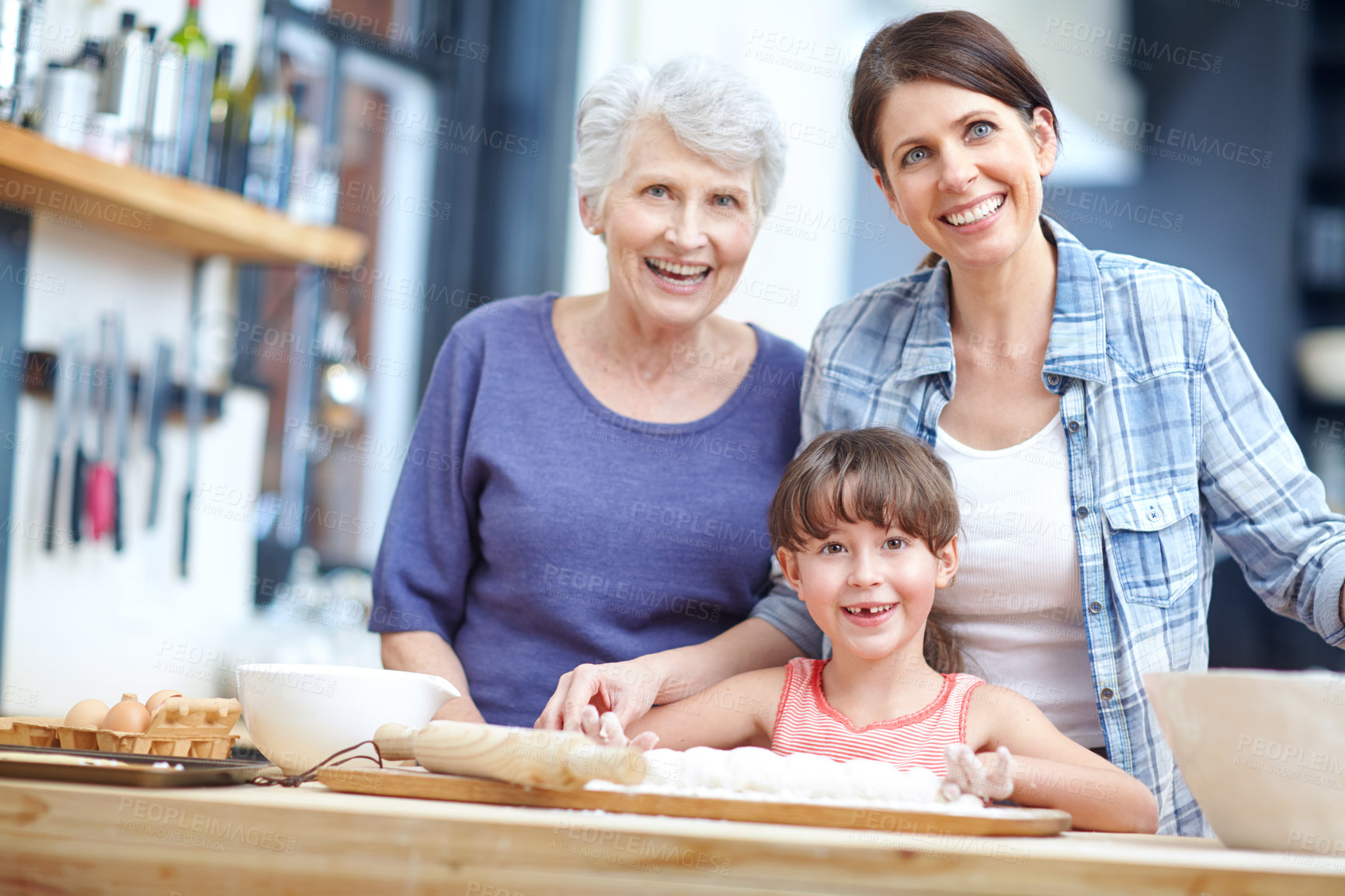 Buy stock photo Portrait of a three generational family baking together