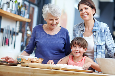 Buy stock photo Shot of a three generational family baking together