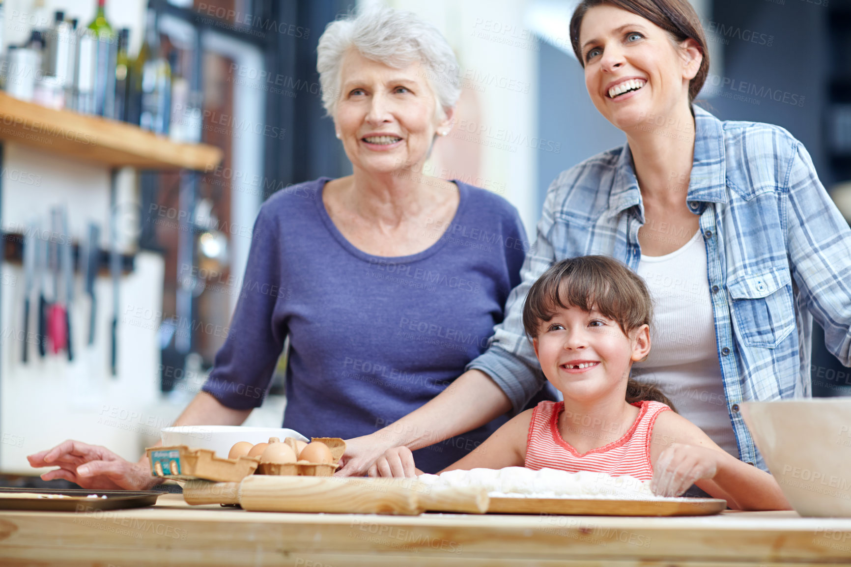 Buy stock photo Shot of a three generational family baking together