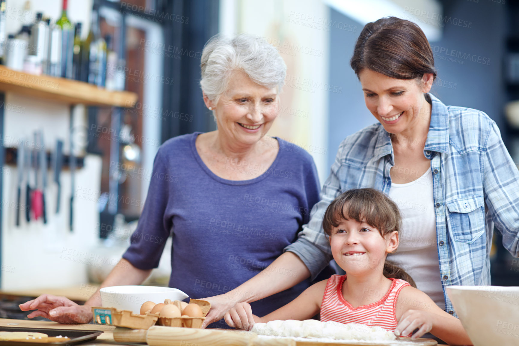 Buy stock photo Shot of a three generational family baking together