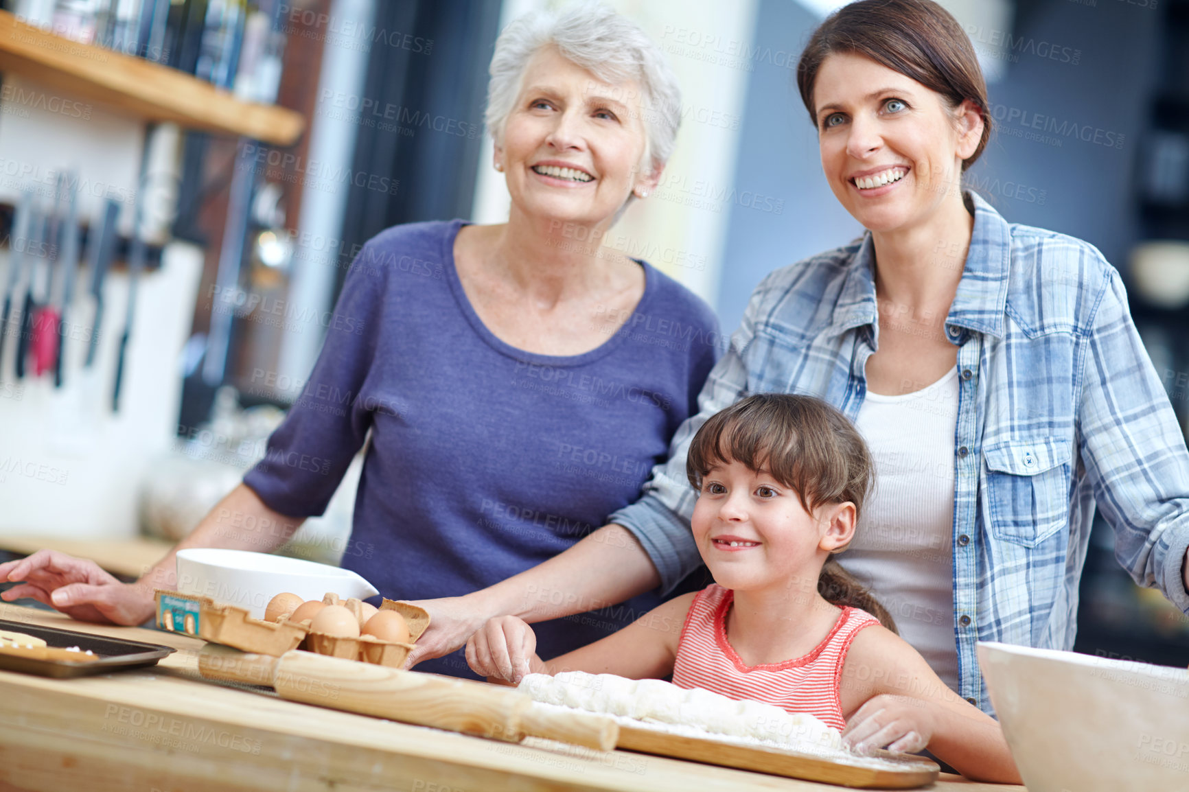 Buy stock photo Shot of a three generational family baking together