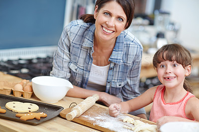 Buy stock photo Shot of a mother and daughter baking together