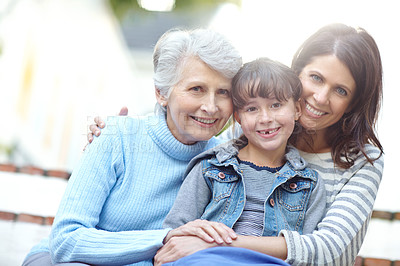 Buy stock photo Portrait of a three generational family sitting outdoors