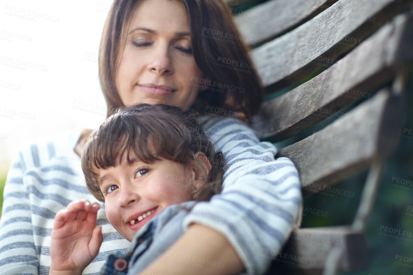 Buy stock photo Shot of a mother and daughter lying together on a hammock