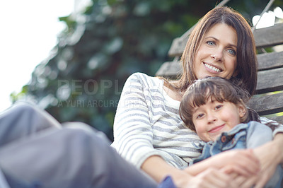 Buy stock photo Shot of a mother and daughter lying together on a hammock