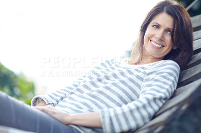 Buy stock photo Shot of a beautiful woman lying on a hammock outdoors
