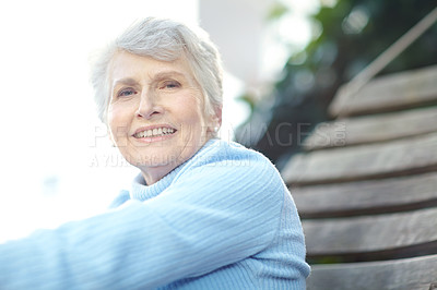 Buy stock photo Cropped shot of a senior woman lying on a hammock and enjoying the outdoors