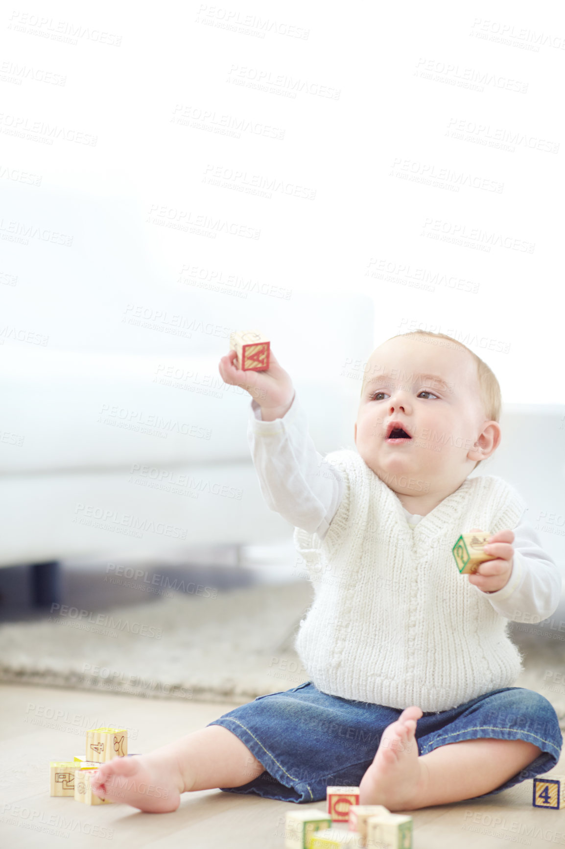 Buy stock photo Boy, toddler and playing with wooden blocks on floor for childhood development or cognitive learning. Youth, child or playful kid with toys for fine motor skills, coordination or building in home