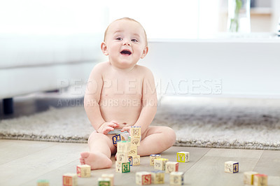 Buy stock photo Shot of an adorable little boy wearing his diaper while playing with his blocks