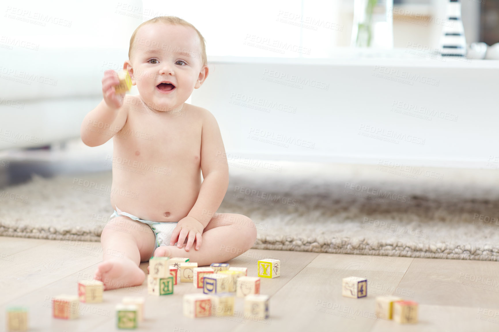 Buy stock photo Happy boy, toddler and home with building blocks for playing, childhood development or learning. Youth, child or playful kid with toys for fine motor skills, cognitive or coordination in house